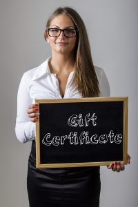 Gift Certificate - Young businesswoman holding chalkboard with text - vertical image