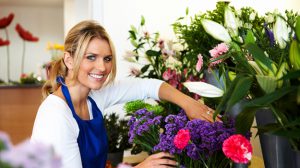 Image of smiling female florist working at flower shop